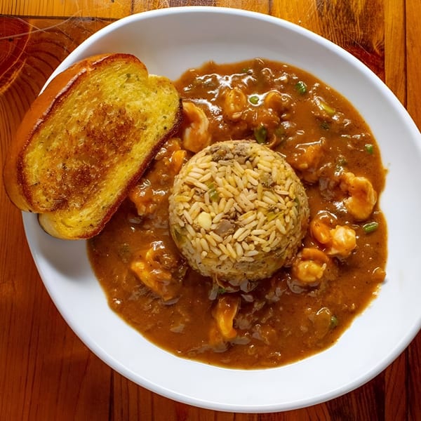 Boudreaux's II Willowbrook's shrimp and rice dish with a side of toasted garlic bread.